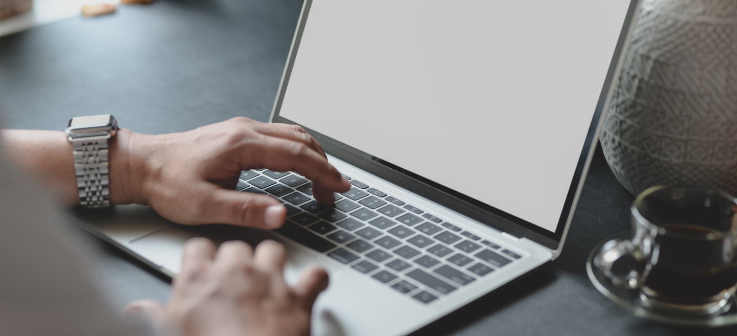 A Cup of Espresso Beside  a Man Using Computer Laptop